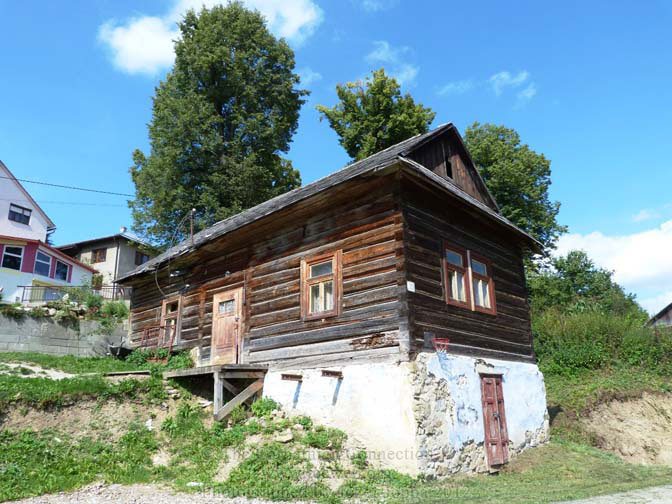 Log Home below the church